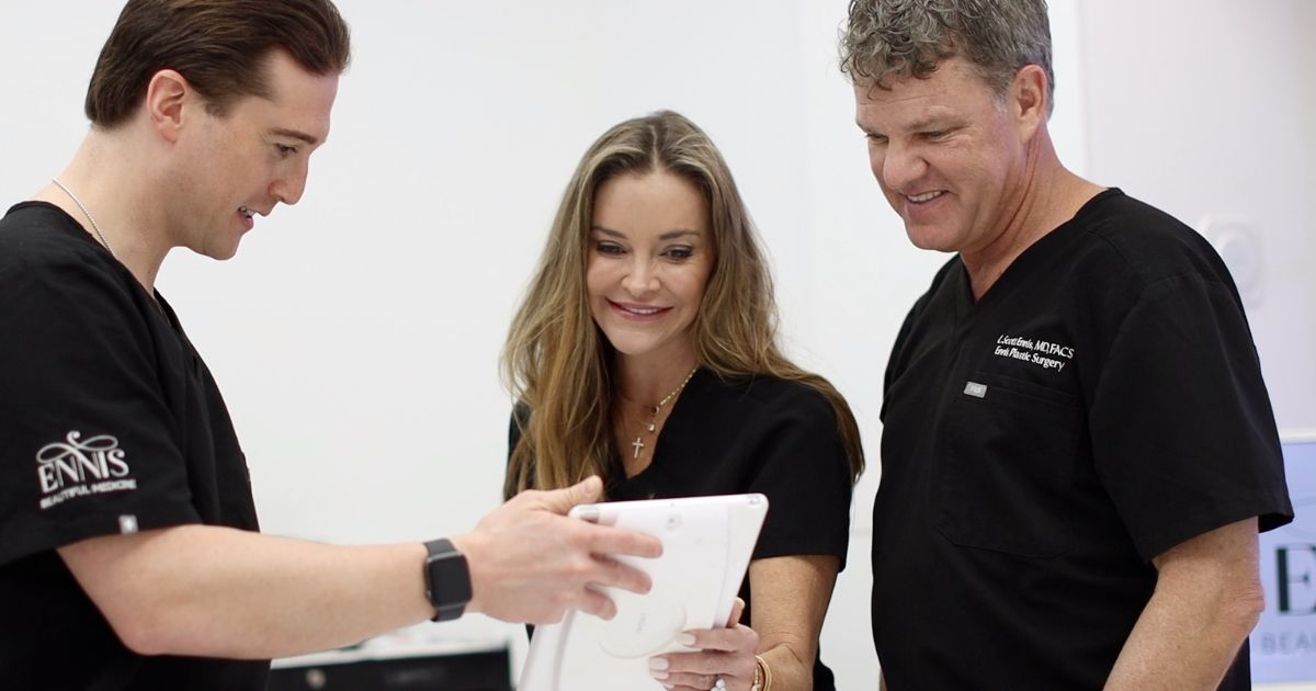 Dr. Vincent Riccelli with the Ennis Plastic Surgery team reviewing a breast surgery plan